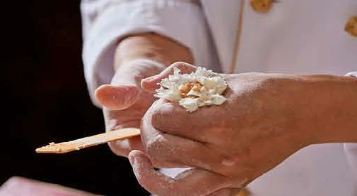 Shaping the gathered shaomai by hand.